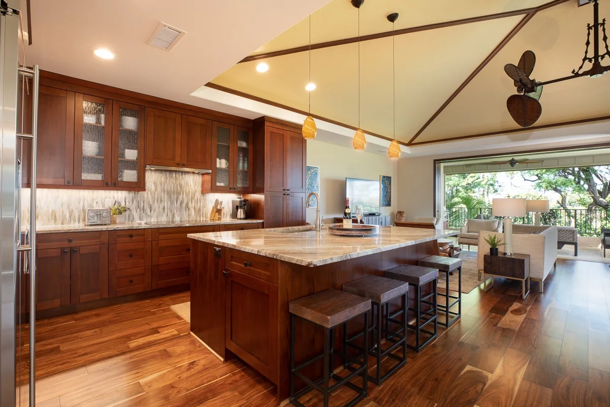 A spacious kitchen with a central island and an open dining area.
