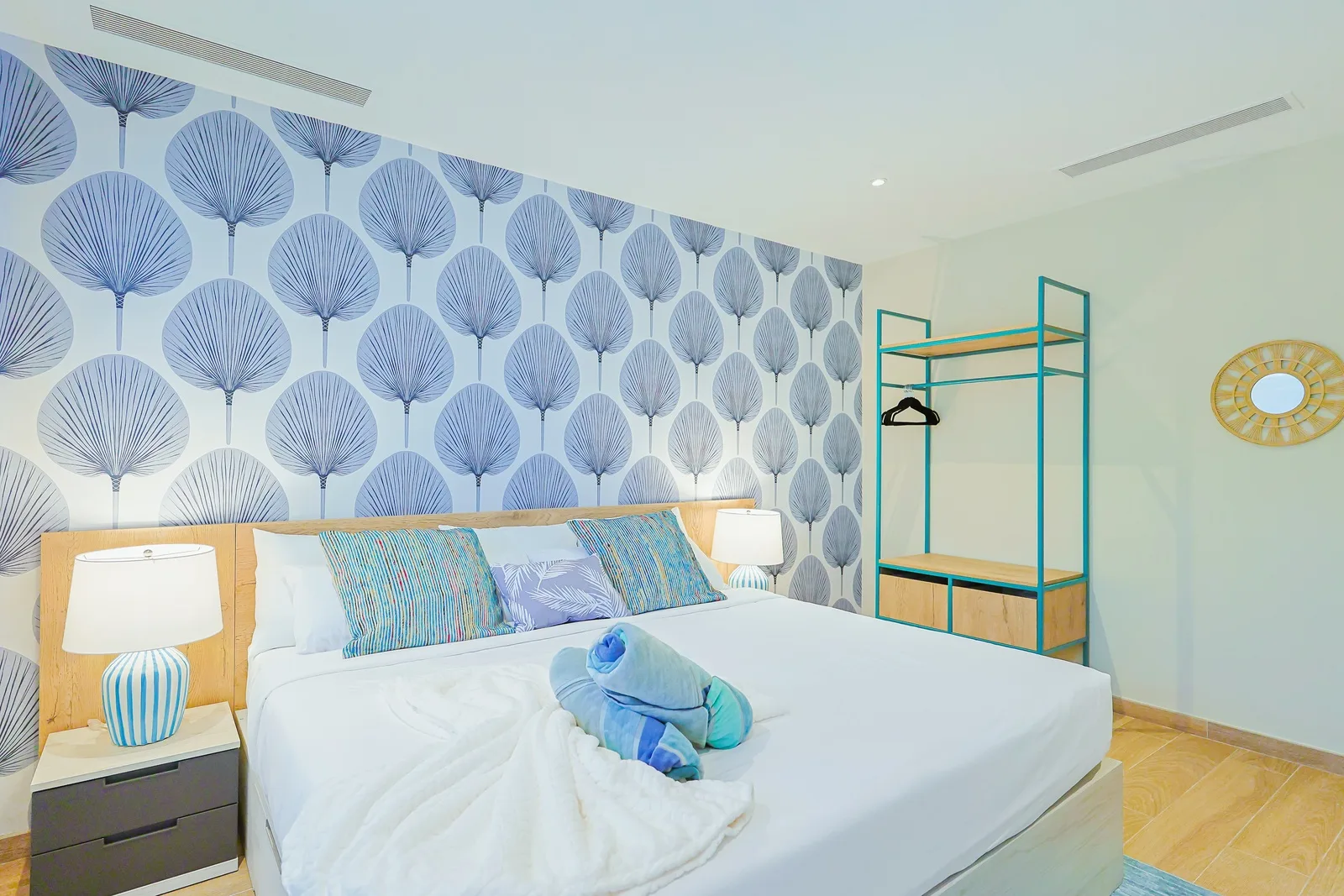 Sink into crisp linens and rest easy in your serene coastal retreat, where soothing blue tones and natural textures set the stage for complete relaxation.