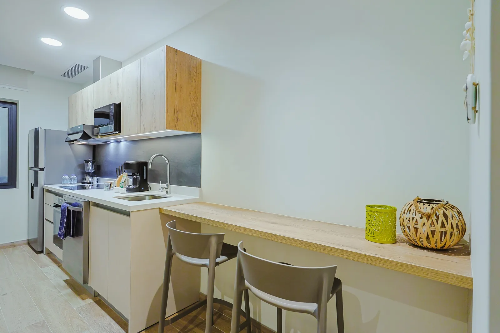 Enjoy your morning coffee or evening meal at the sleek breakfast bar, perfectly positioned beside your modern, fully-equipped kitchen. The bright, airy space invites relaxation and easy entertaining.