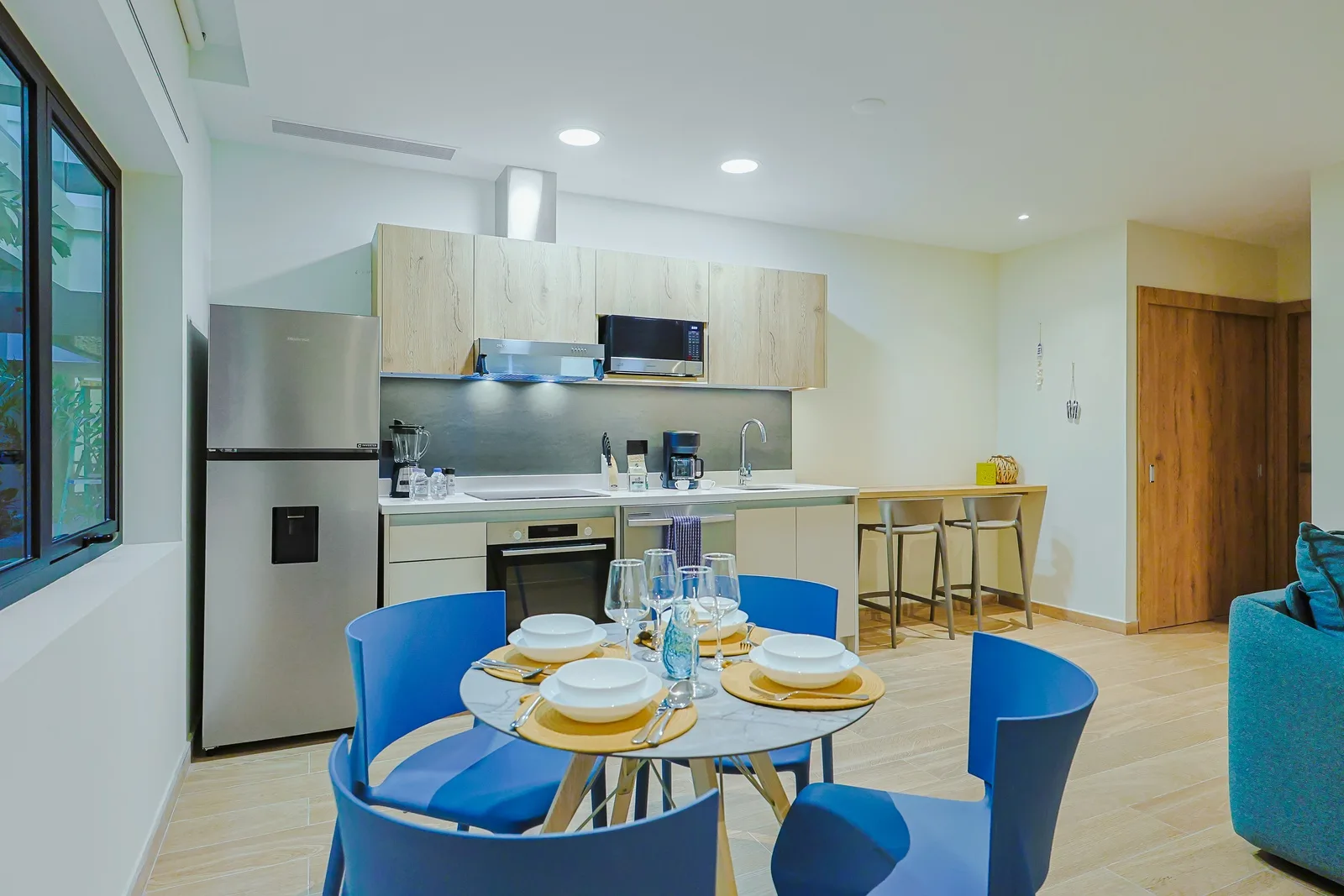 Prepare your favorite meals in this bright, modern kitchen with stainless appliances and ample counter space. The open layout flows seamlessly to your dining area, perfect for gathering over home-cooked meals.