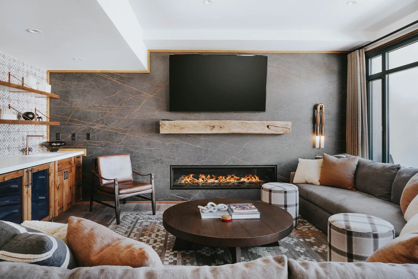 A living room with a fireplace, television, and seating around a coffee table.