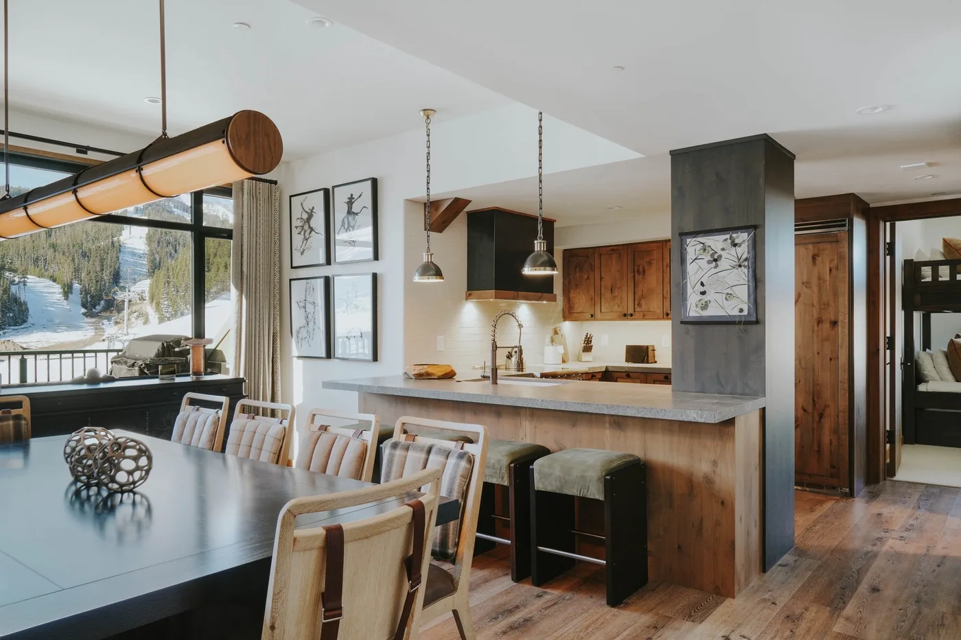 An open dining and kitchen area with a long table and counter seating.