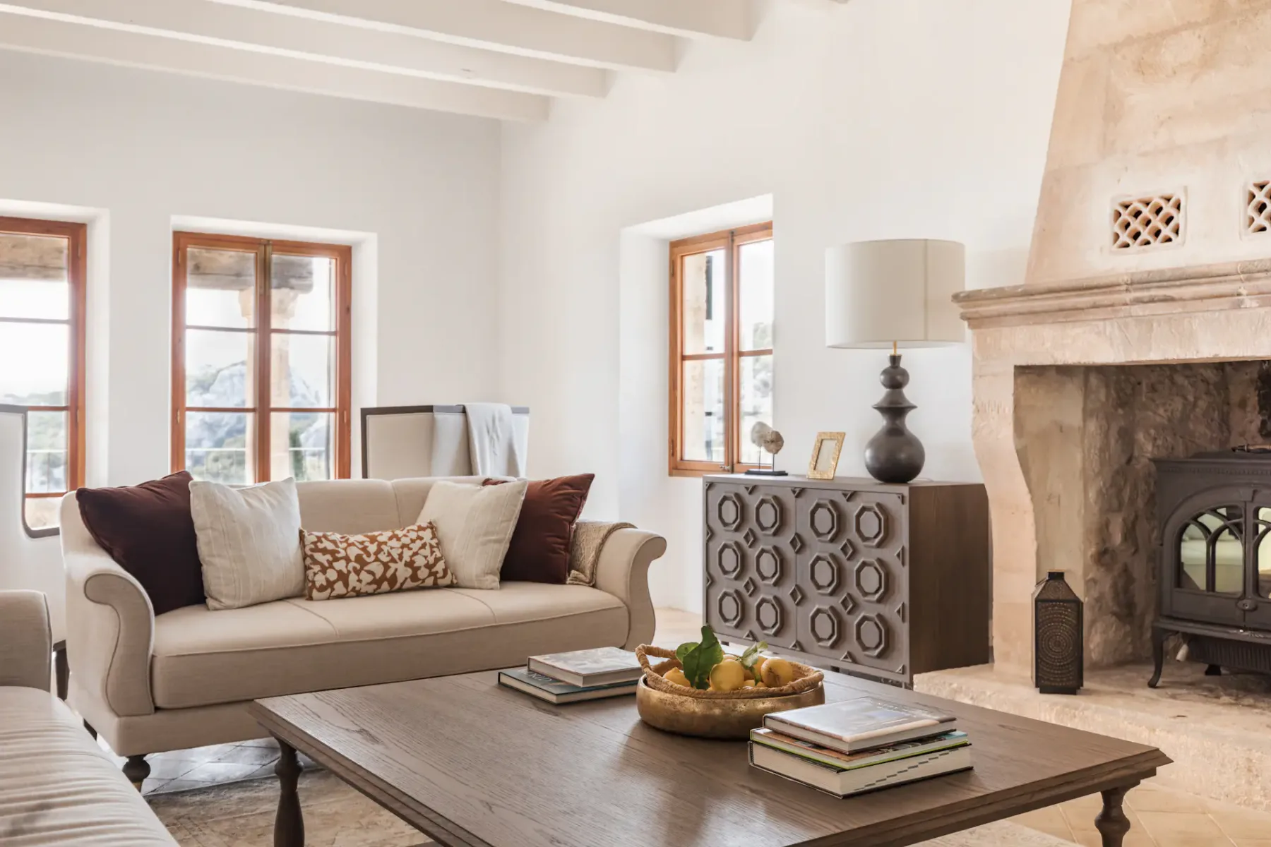 A living room with a sofa, coffee table, and fireplace.