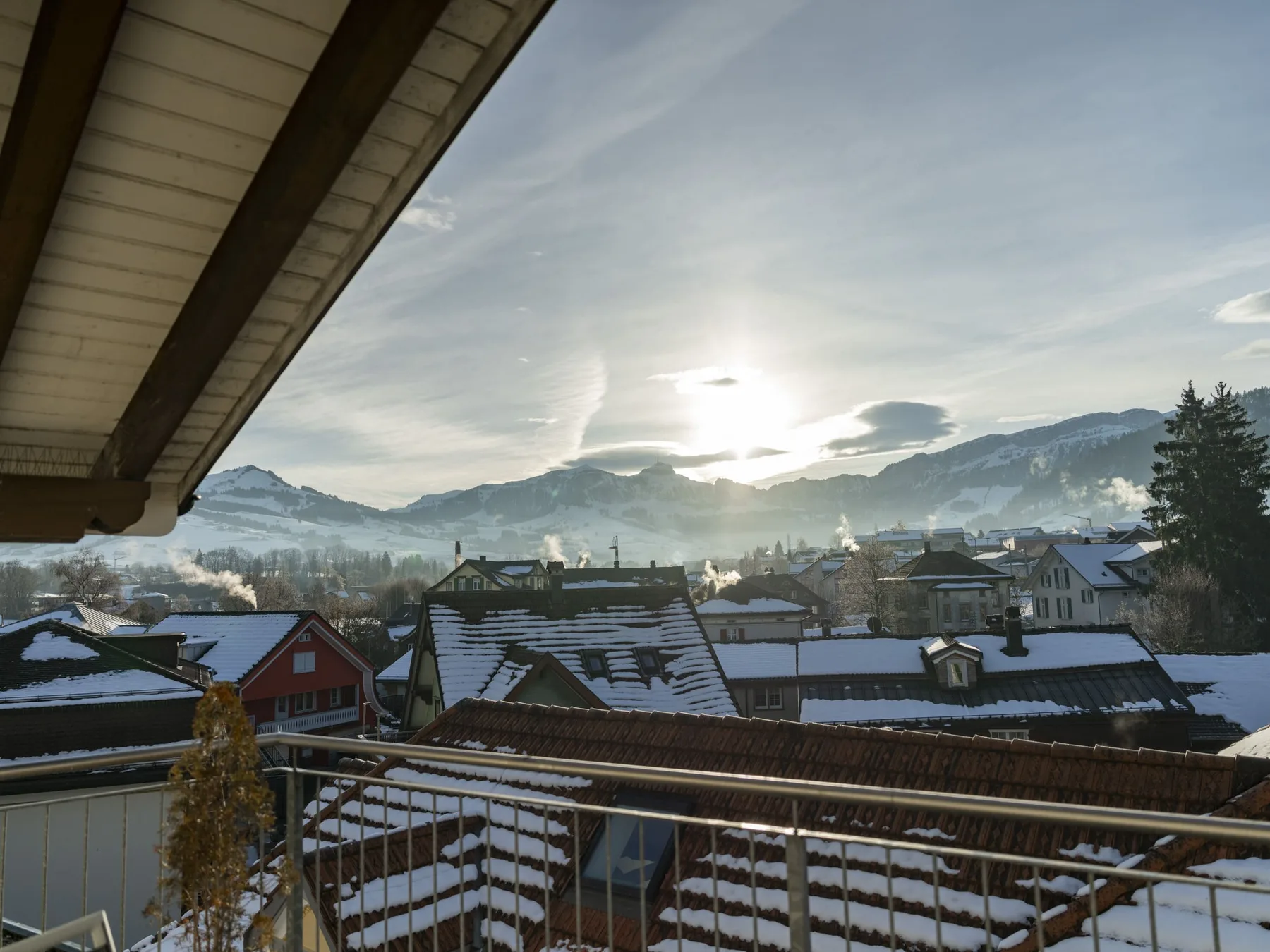 Panoramic view from the suite balcony across Appenzell rooftops toward the Alpstein.
