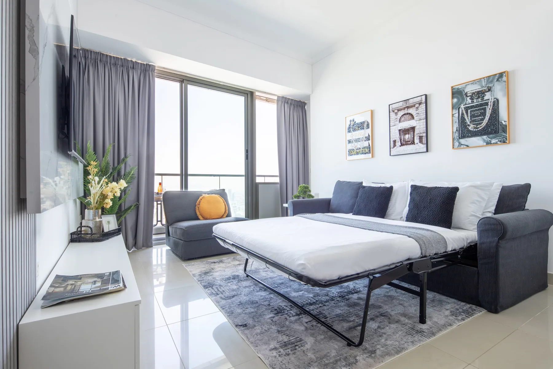 A bright living room with a gray sofa arranged around a low table.
