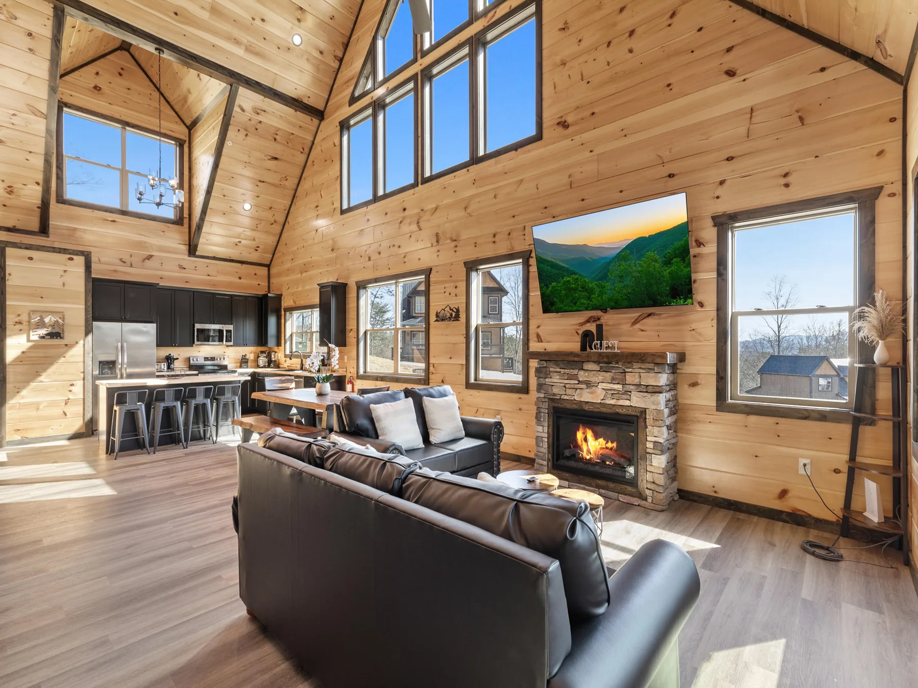 A bright, wood-paneled living room with seating and a fireplace.