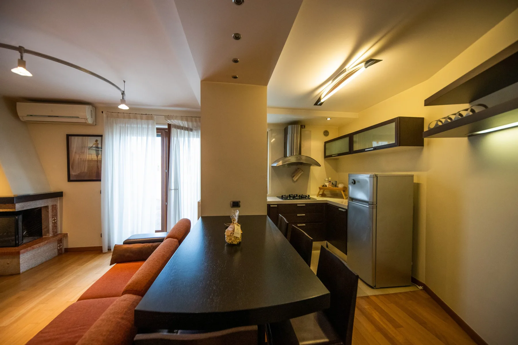 A compact kitchen and dining area with a long counter and seating.