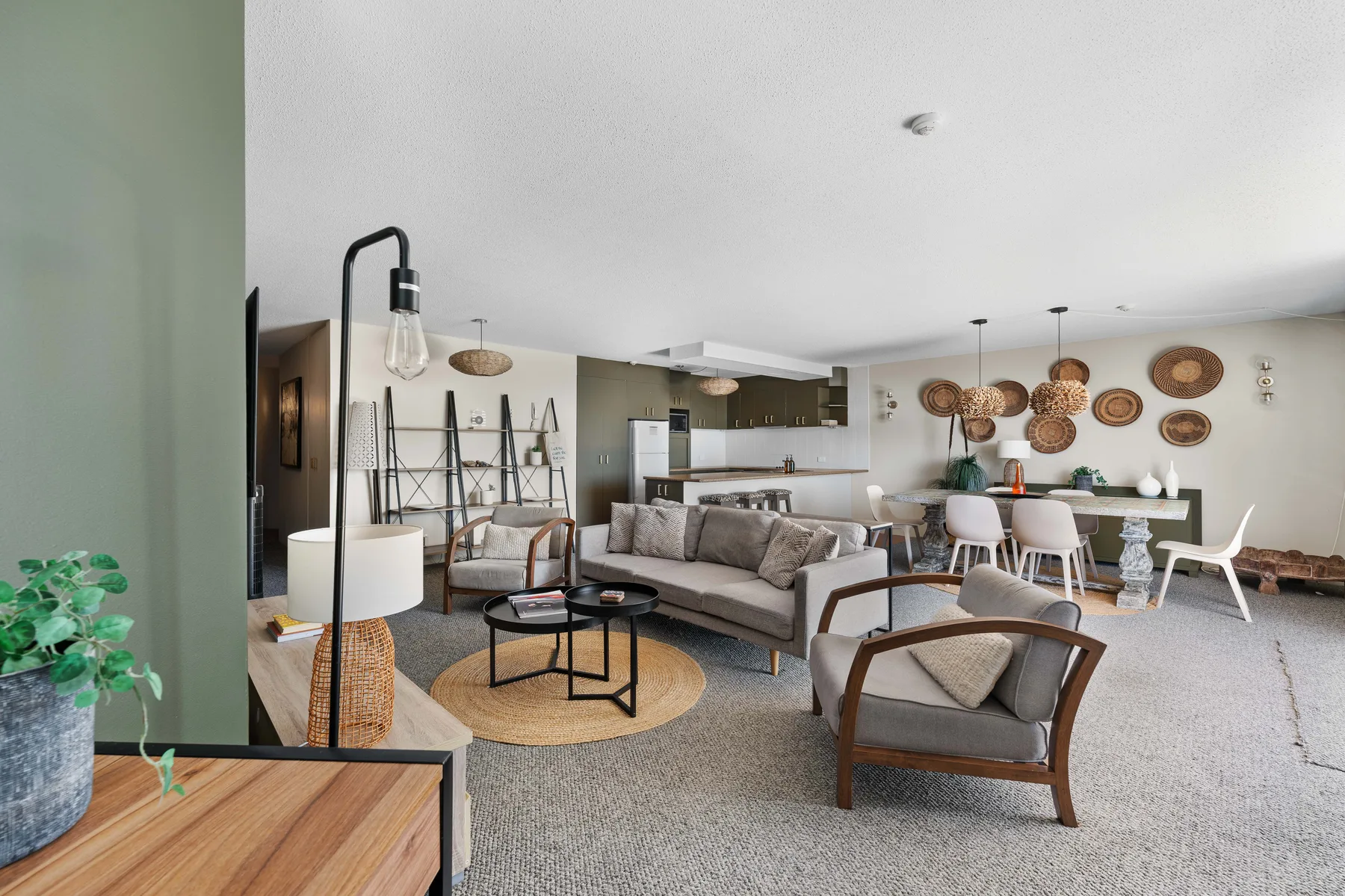 An open-plan living and dining area with seating around a coffee table.
