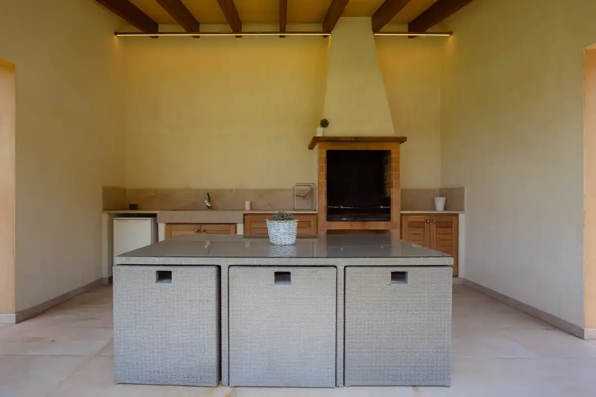 A kitchen with a central island and a built-in fireplace.