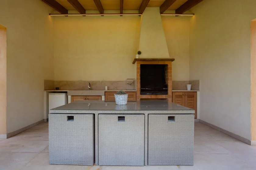 A kitchen with a central island and a built-in fireplace.