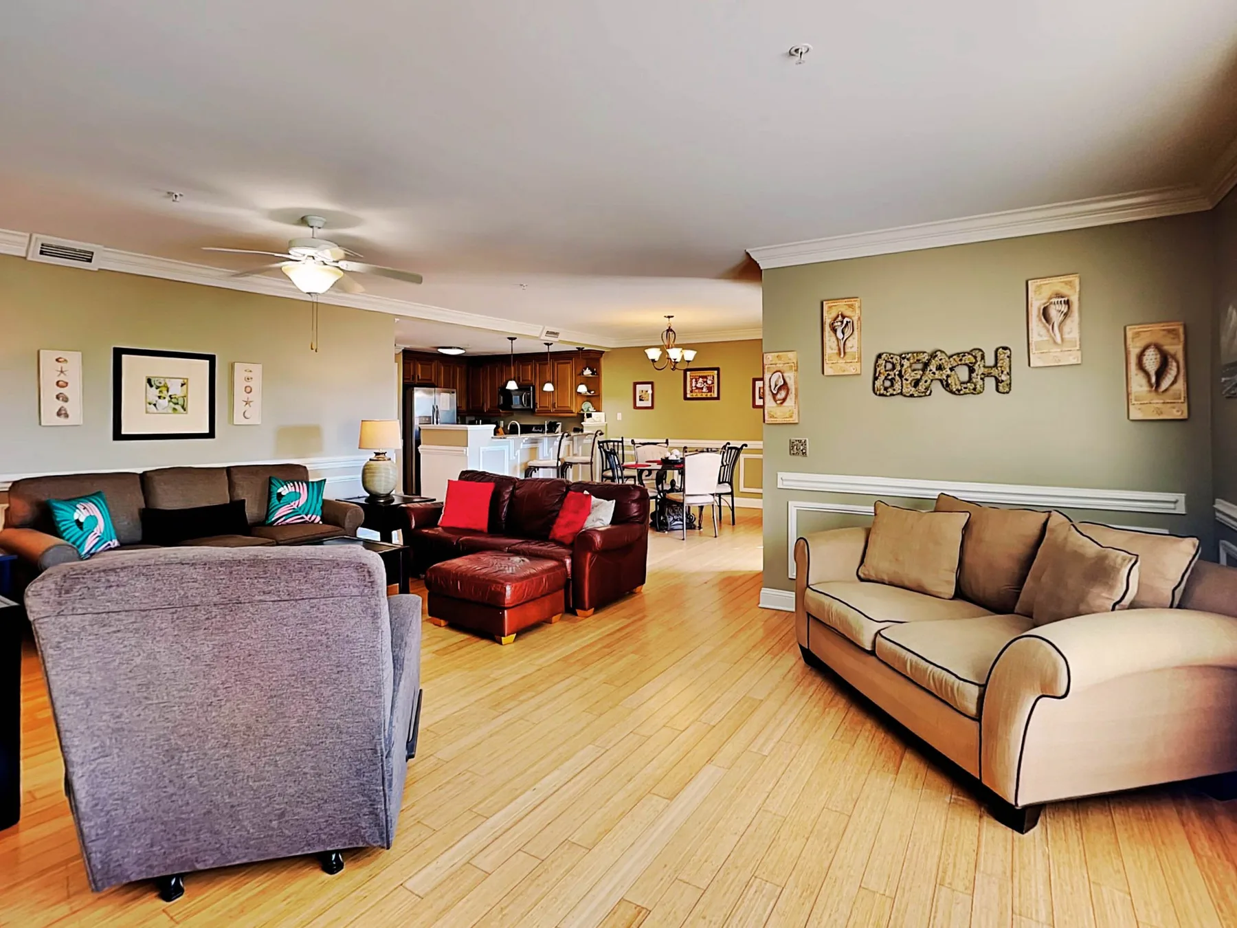 A living room with seating and a dining area visible beyond.