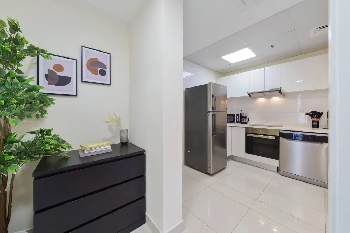 A bright kitchen with white cabinets and stainless steel appliances.