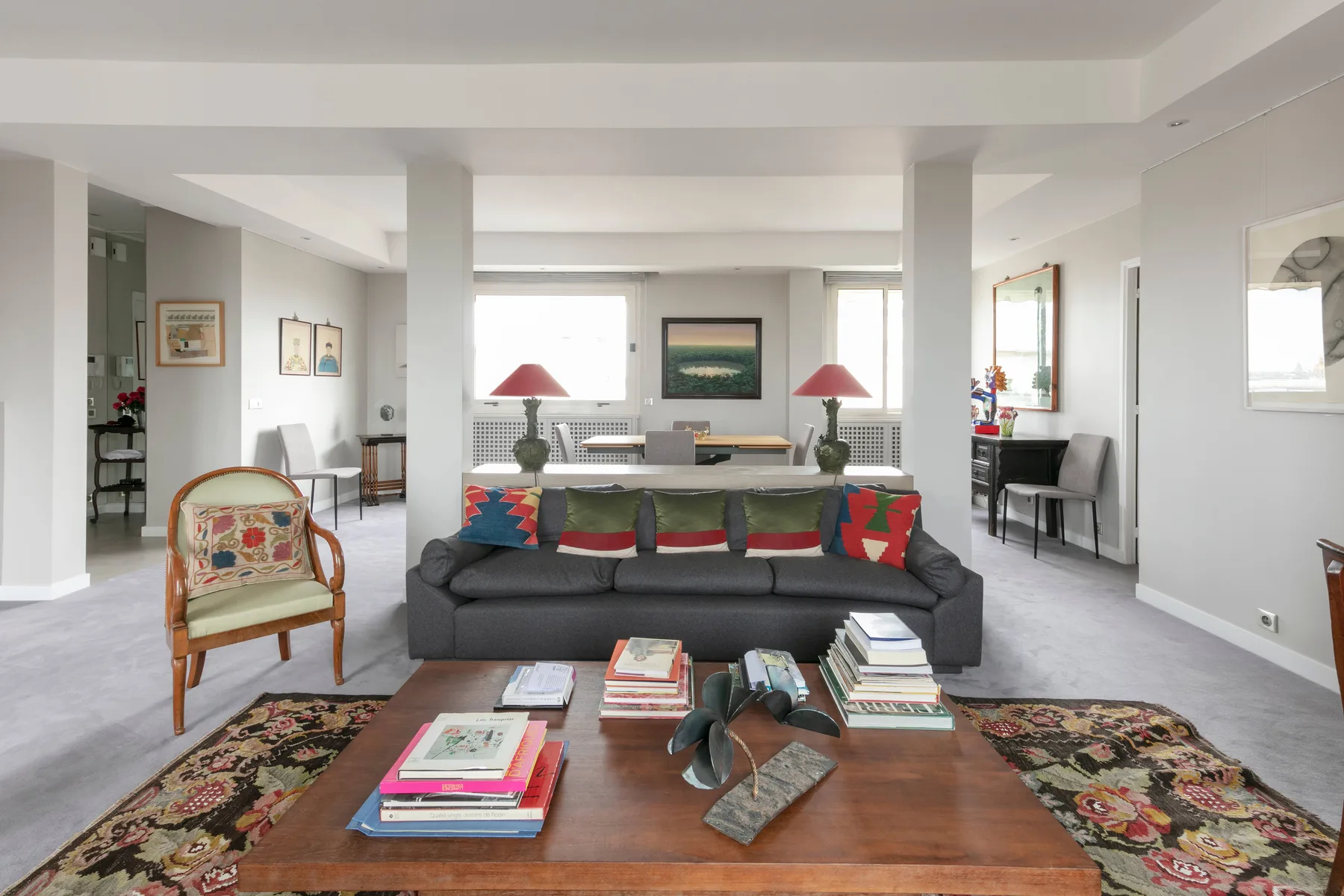 A bright living room with a gray sofa facing a wooden coffee table.
