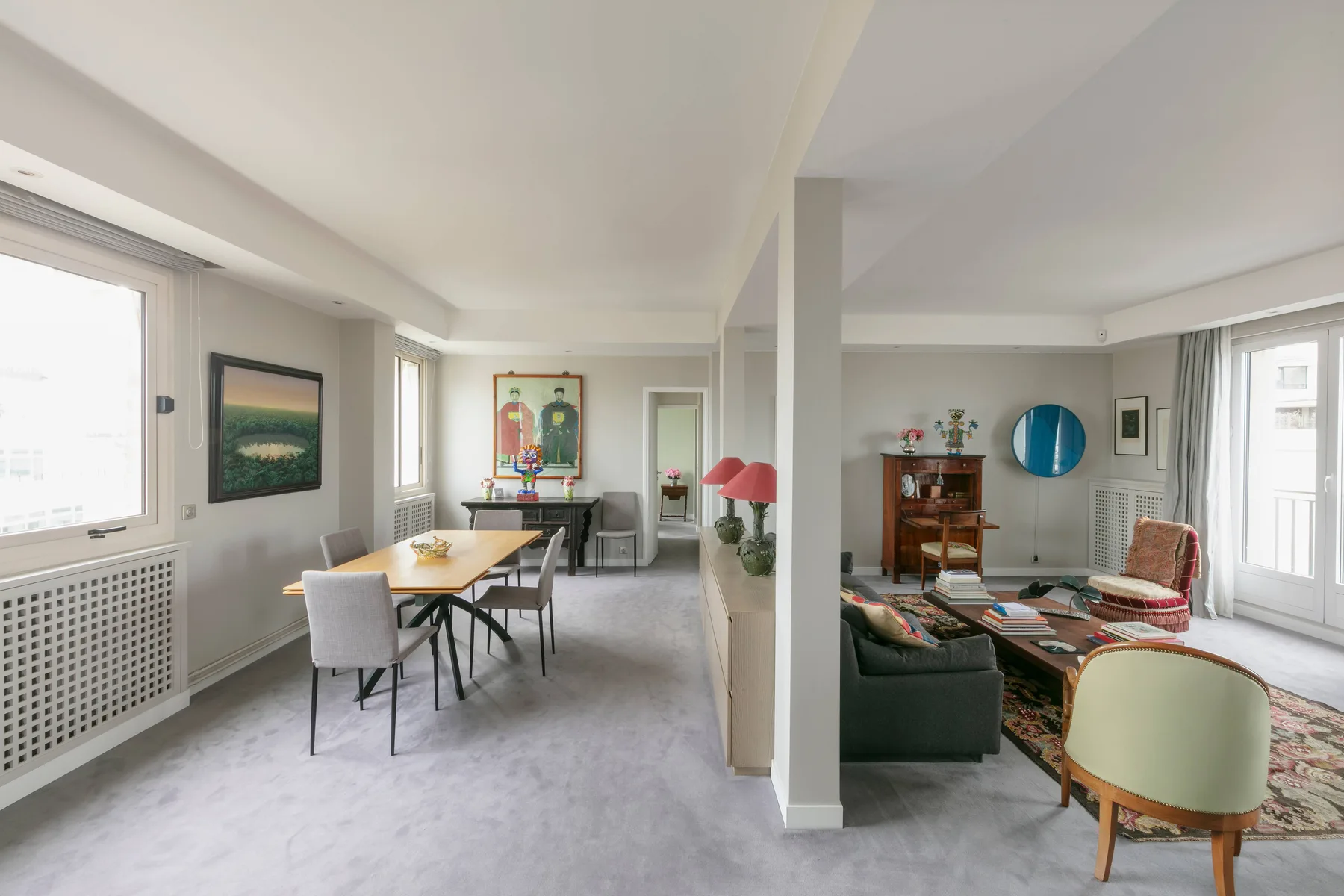 A bright open-plan living and dining room with a table and seating.