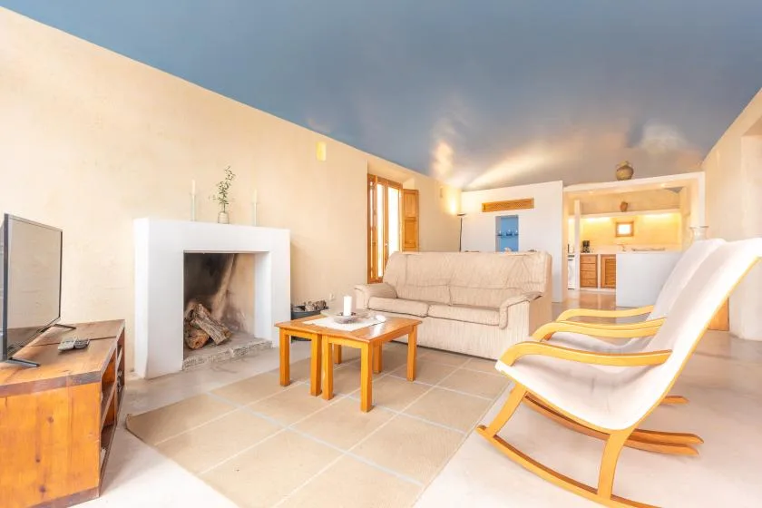 A bright living room with seating around a low wooden coffee table.