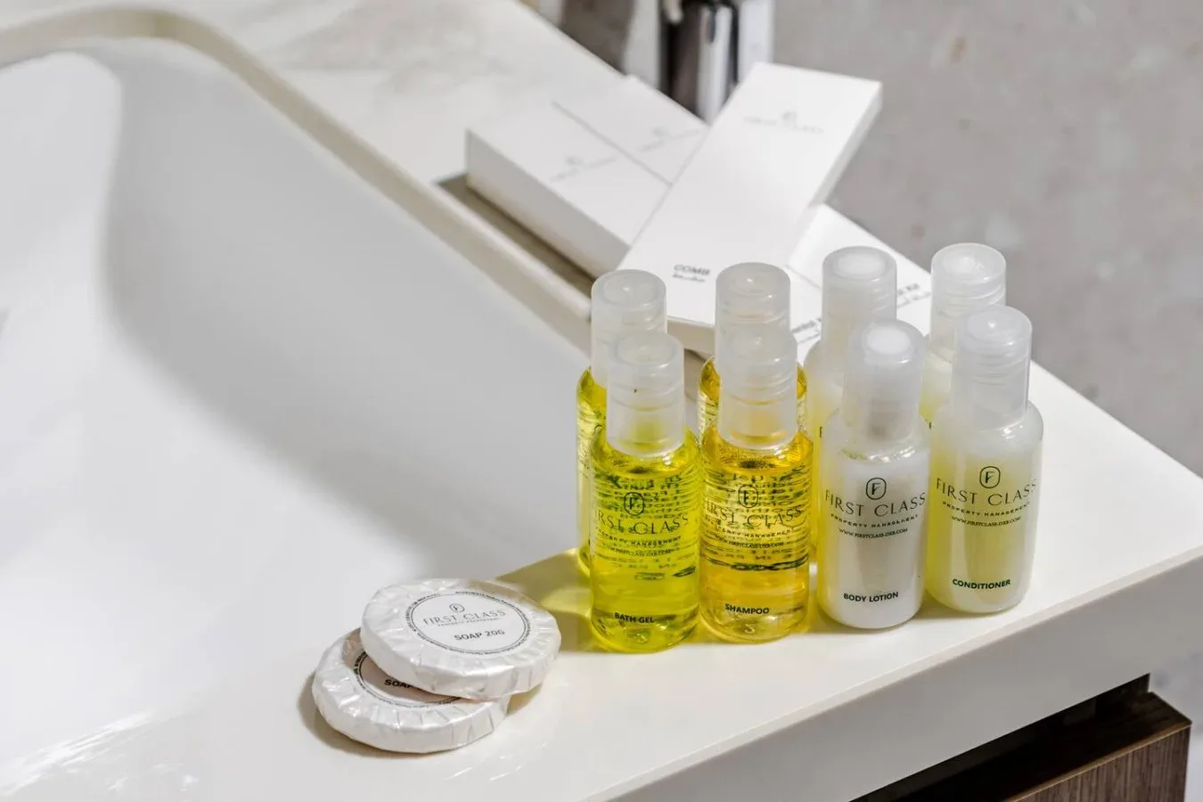 Toiletries arranged on a bathroom sink beside wrapped soap.