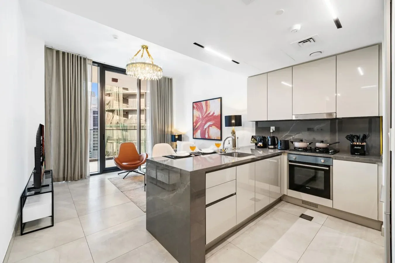 A bright open-plan kitchen and dining area with an island and large windows.