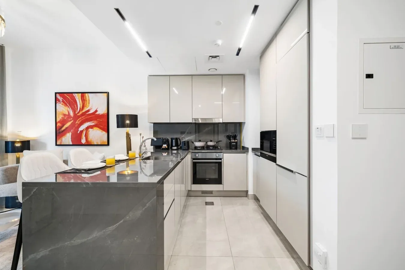 A modern kitchen with a large island and built-in appliances.