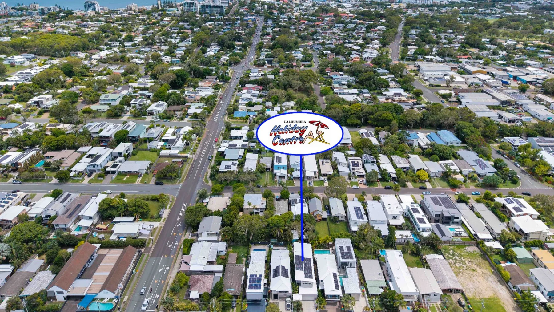 Aerial view of a residential neighborhood with homes and tree-lined streets.