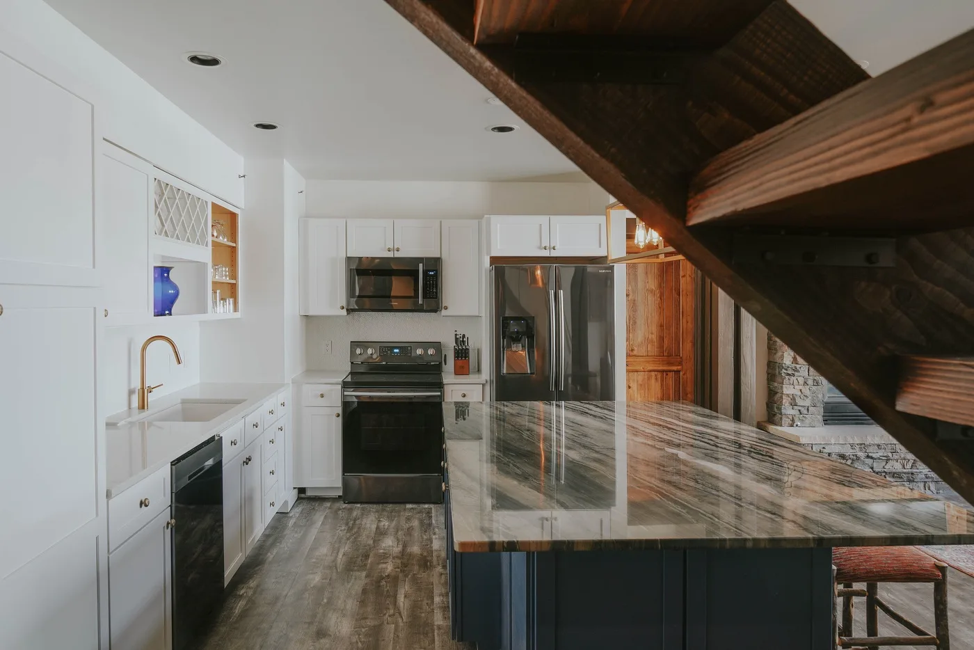 A bright kitchen with white cabinets and a large island.