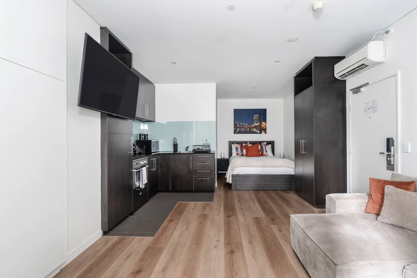 From this view, the open-plan studio connects the living area, kitchen, and sleeping space into one practical layout.