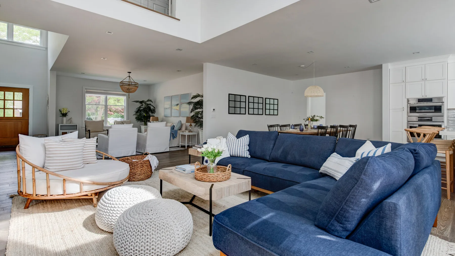 An open-plan living room with blue seating and a light-colored coffee table.