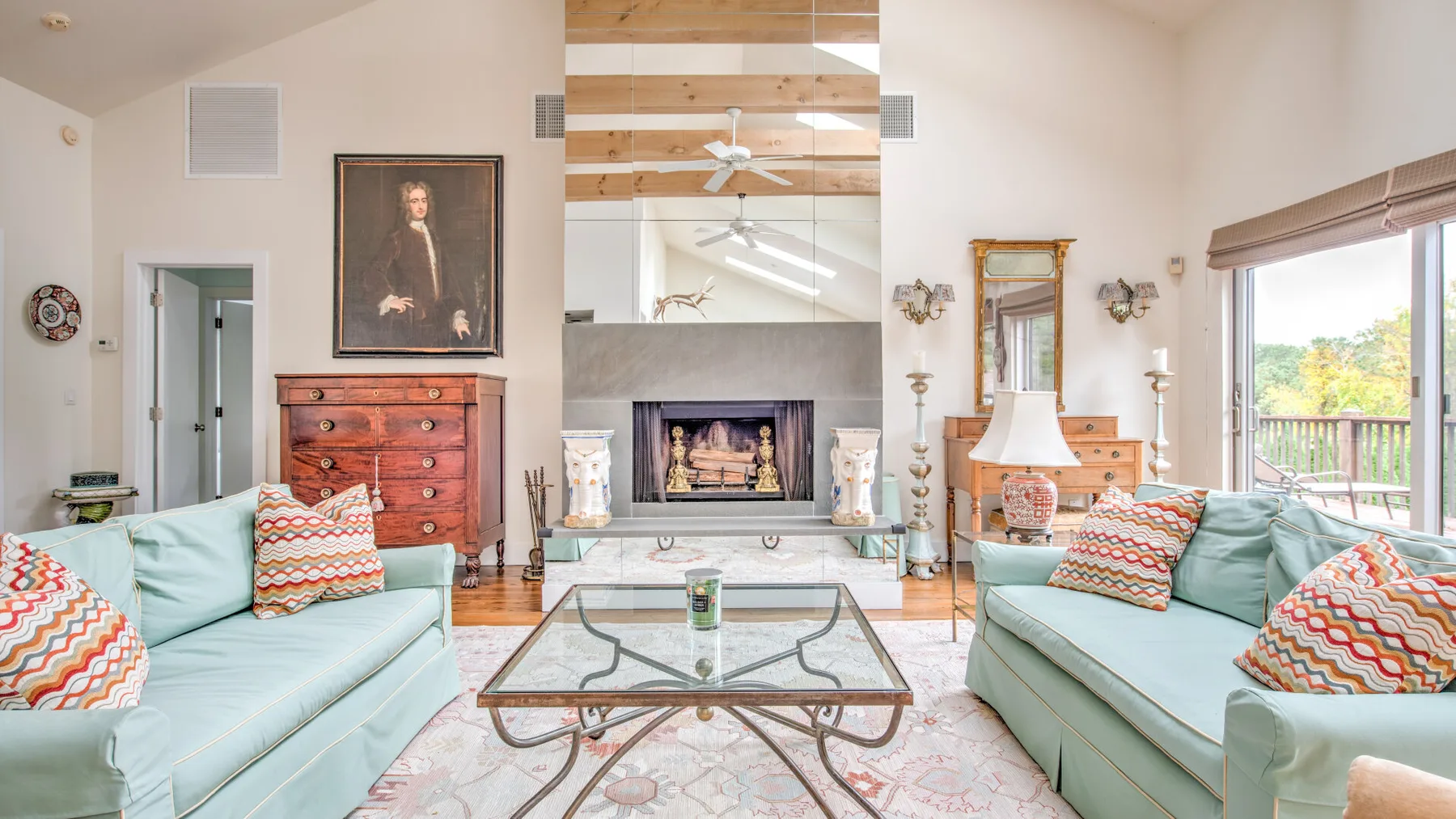 Una sala luminosa con asientos claros, una mesa de centro de vidrio y una chimenea.