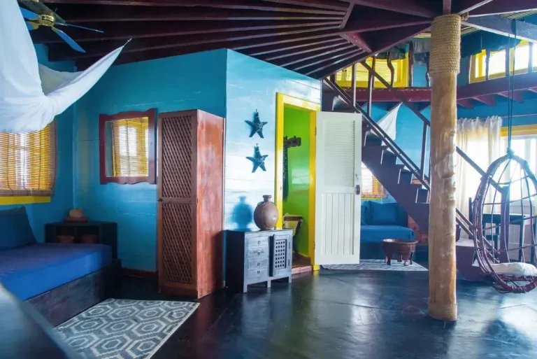 Interior de un palafito con escaleras de madera y luz natural