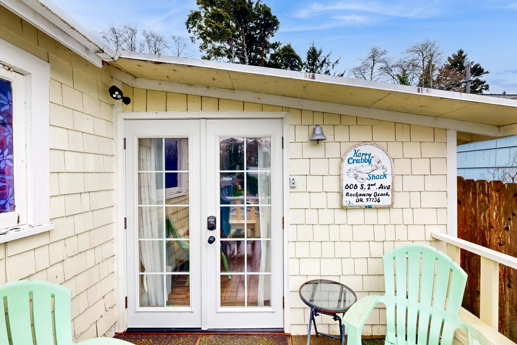 A light-sided exterior entrance has glass double doors and a small seating area.