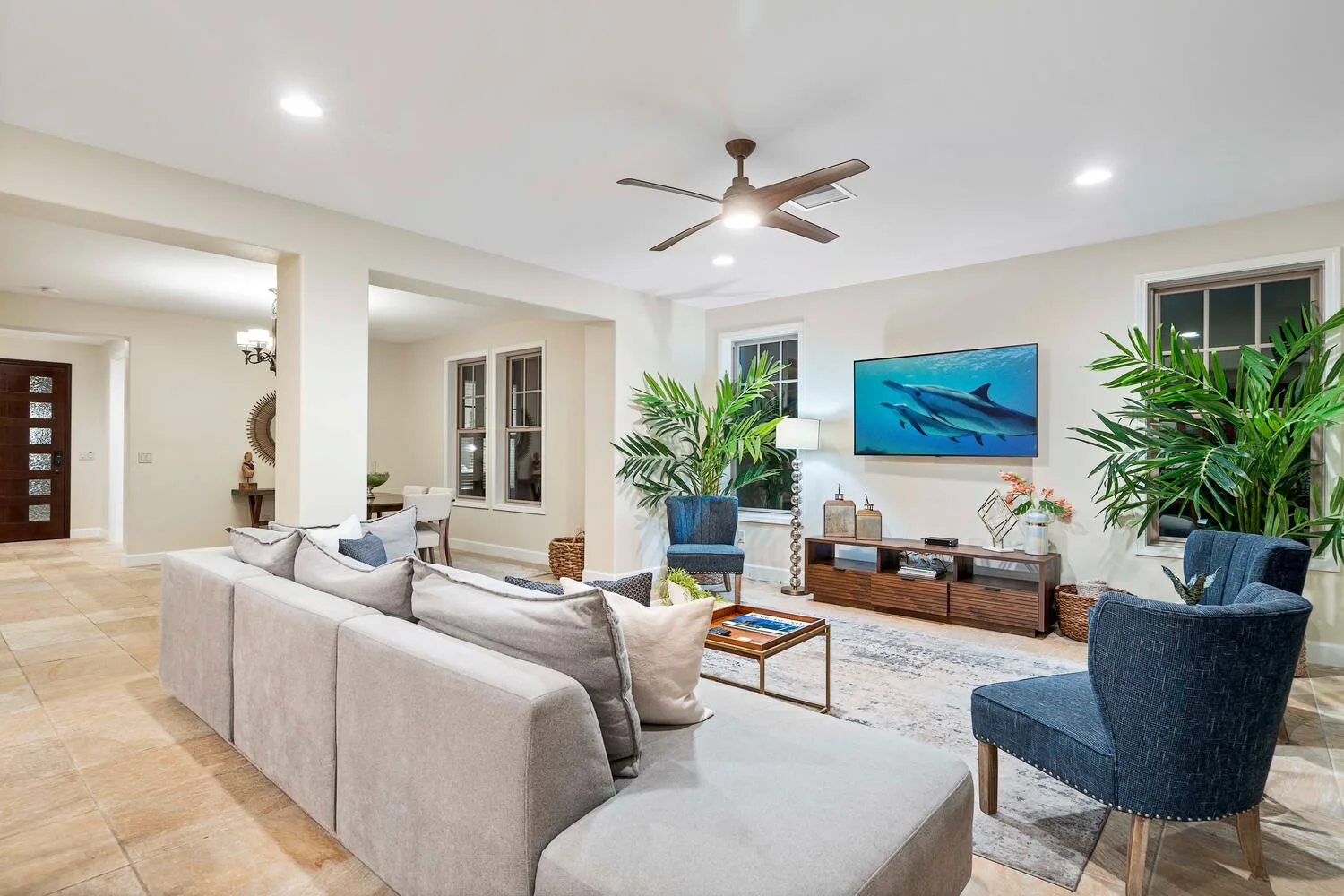 A living room with seating arranged around a television and coffee table.