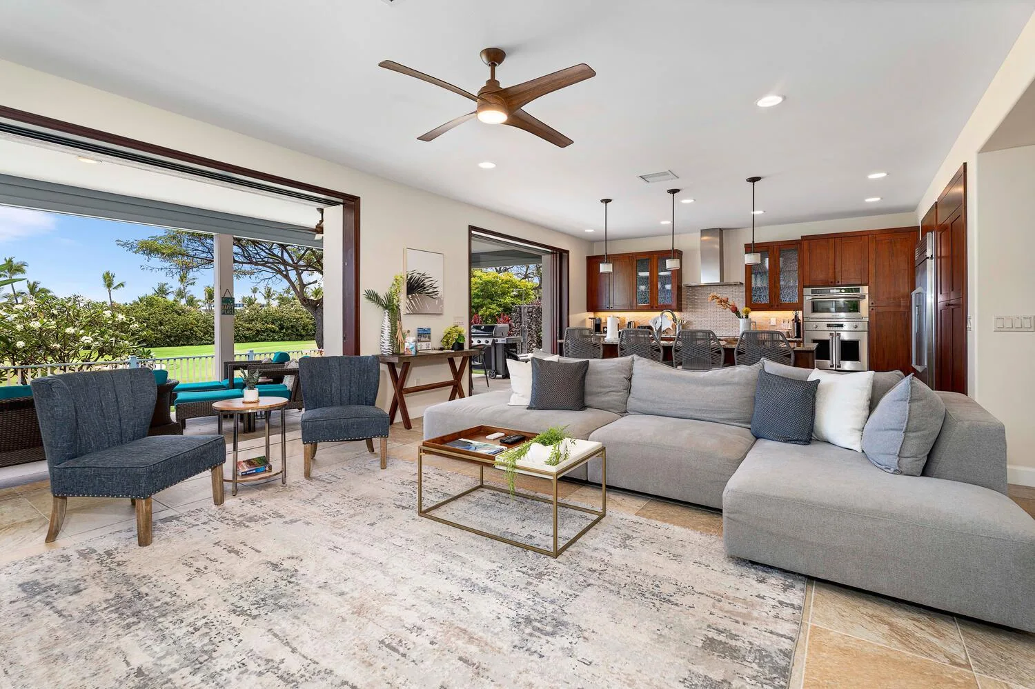 An open-plan living and dining area with seating and a kitchen beyond.