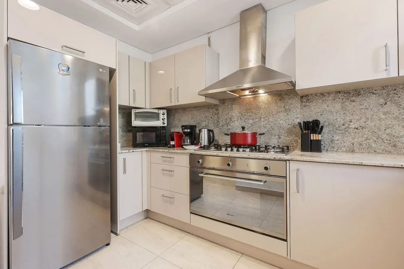 Una cocina moderna y luminosa con electrodomésticos de acero inoxidable y gabinetes claros.