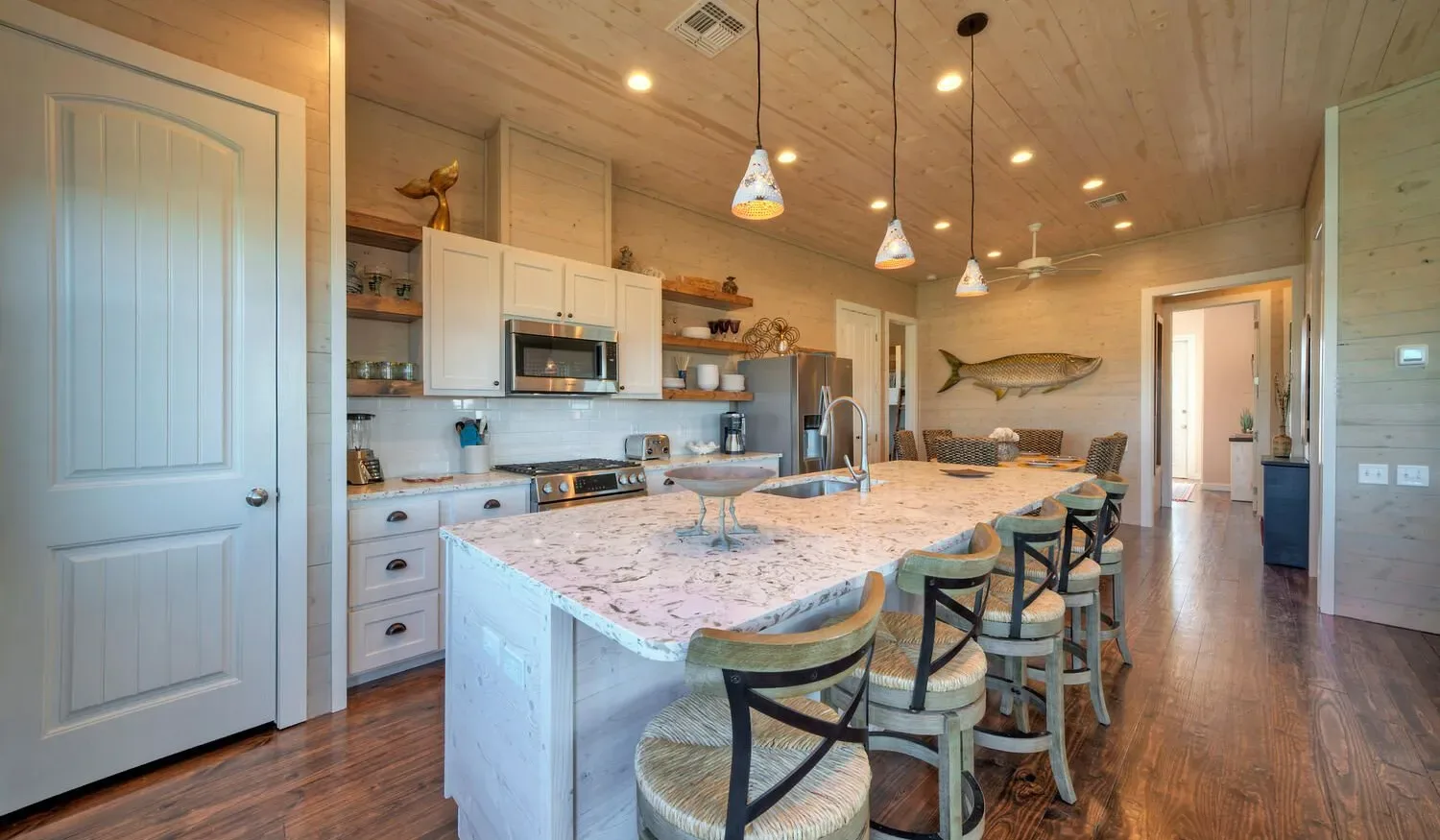 A spacious kitchen with a large island and seating.