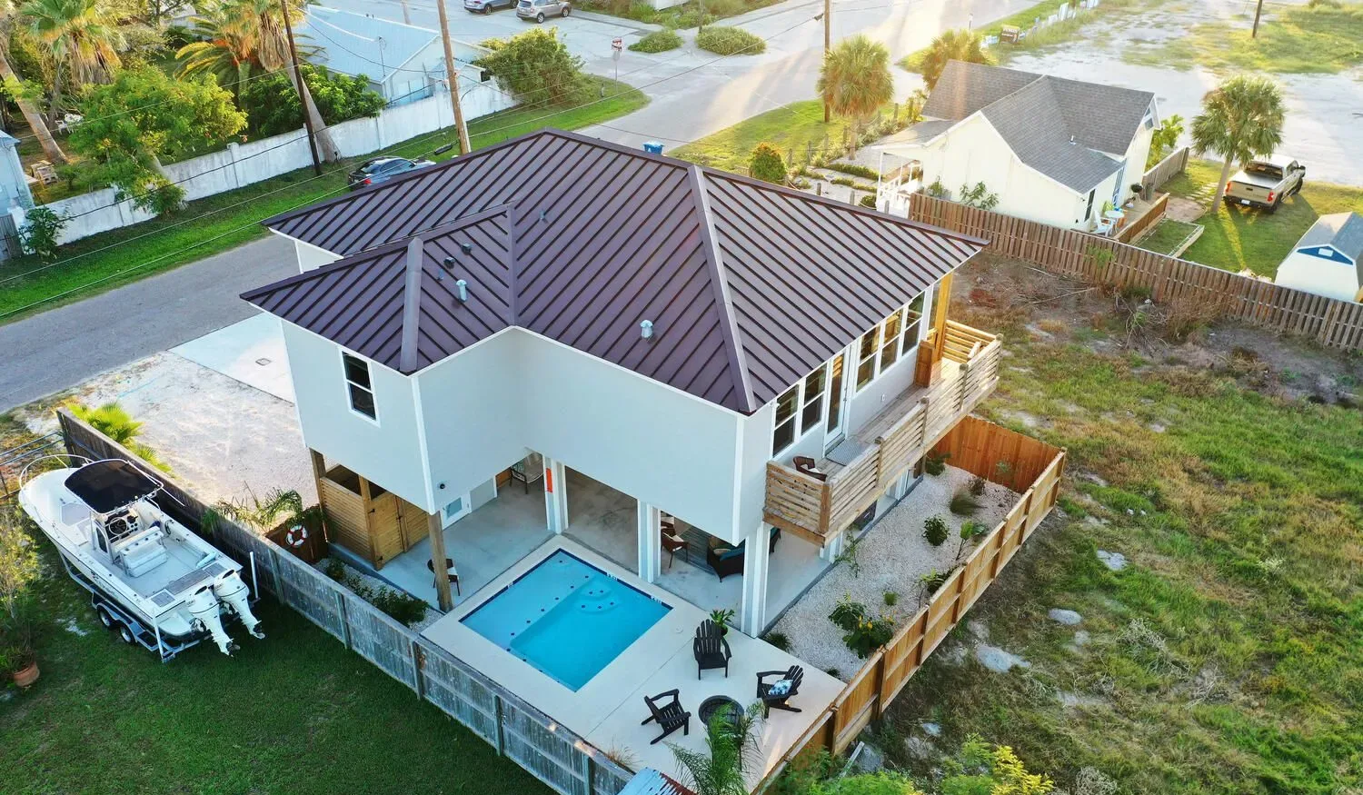 Aerial view of a modern house with a pool on the patio.