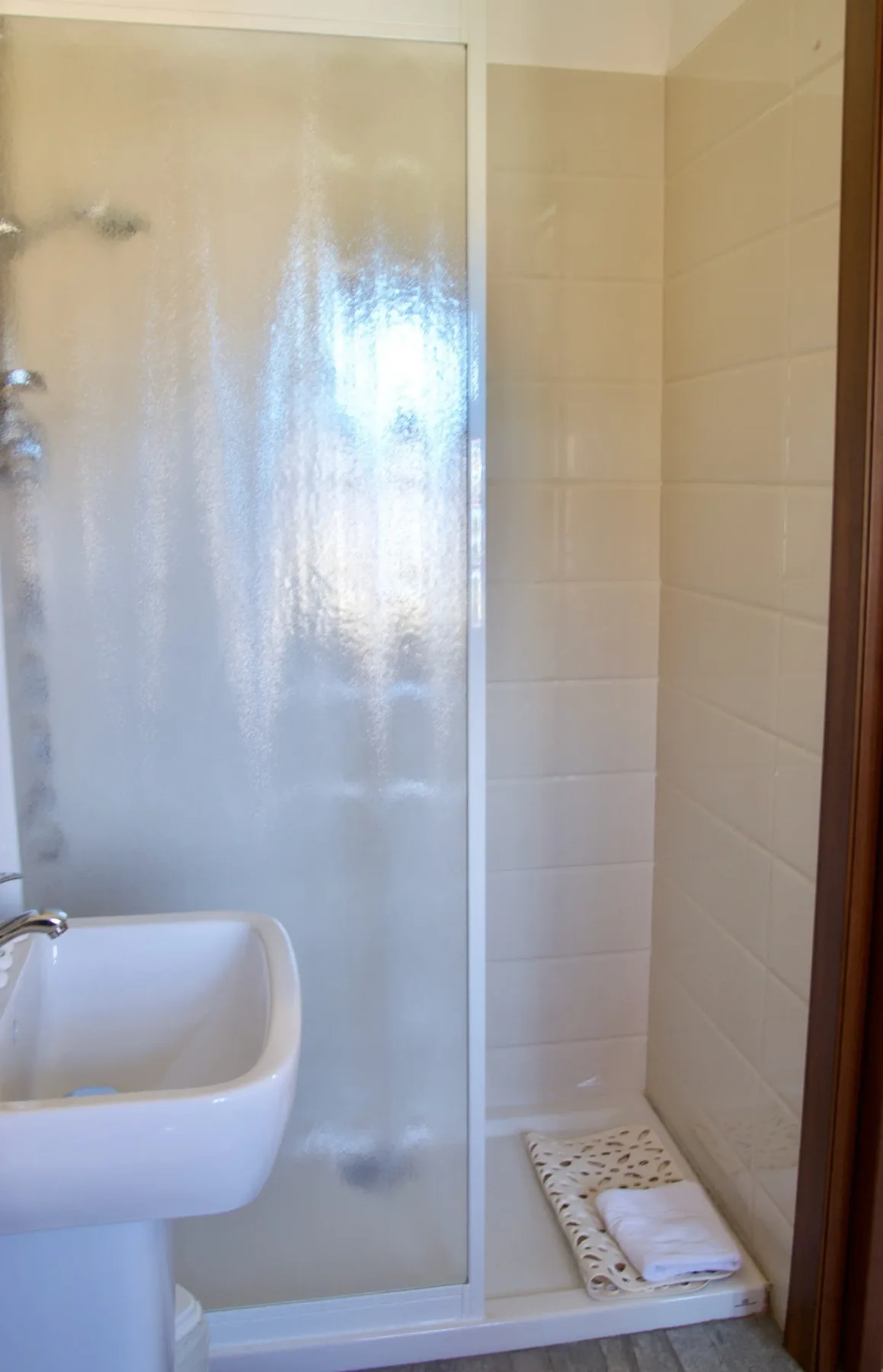 Baño con lavabo y cabina de ducha.