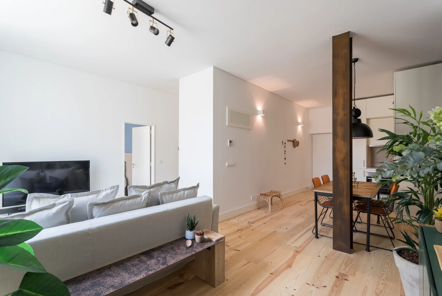 An open-plan living and dining area with seating and a television.