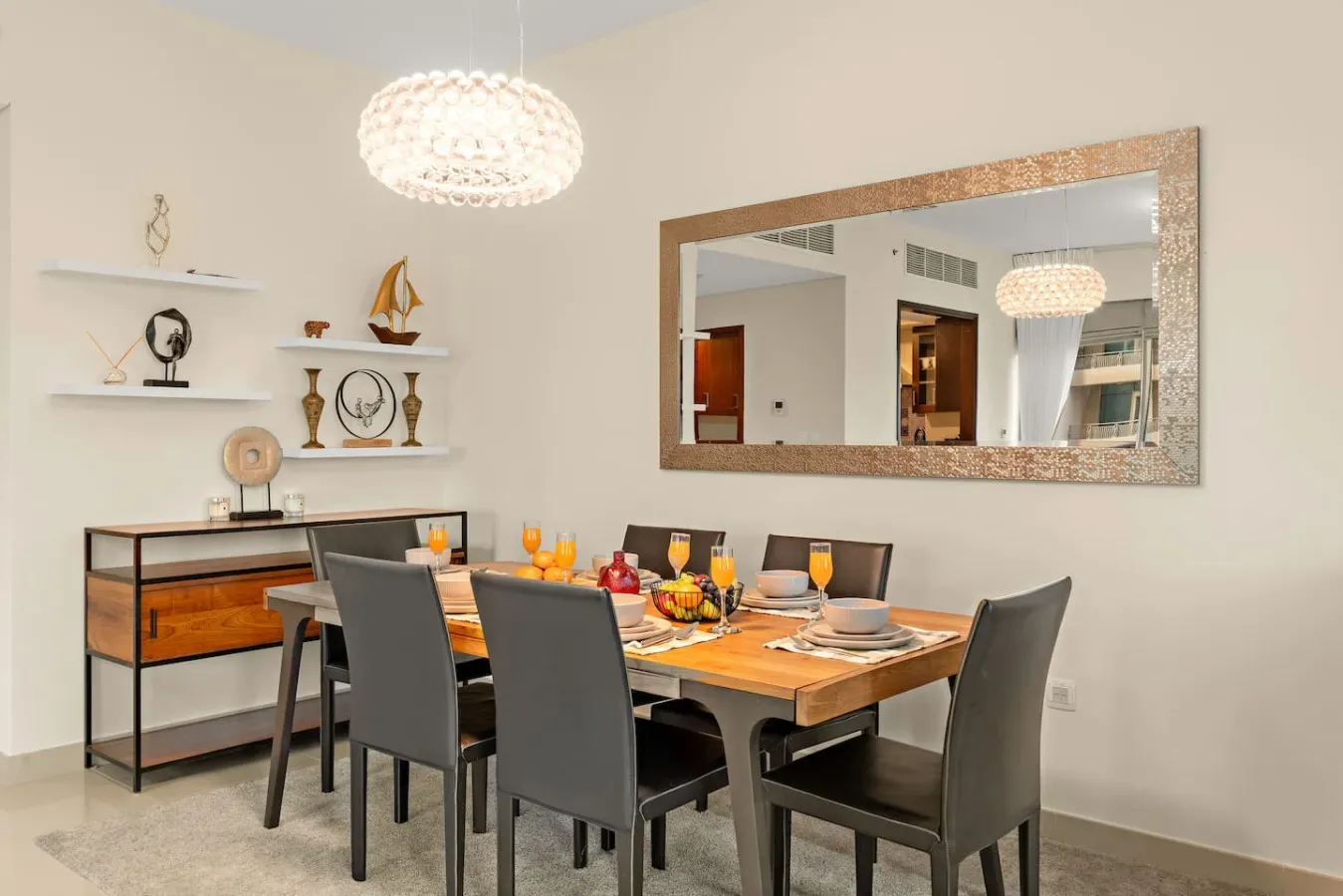 Dining room with a wooden table set beneath a pendant light.