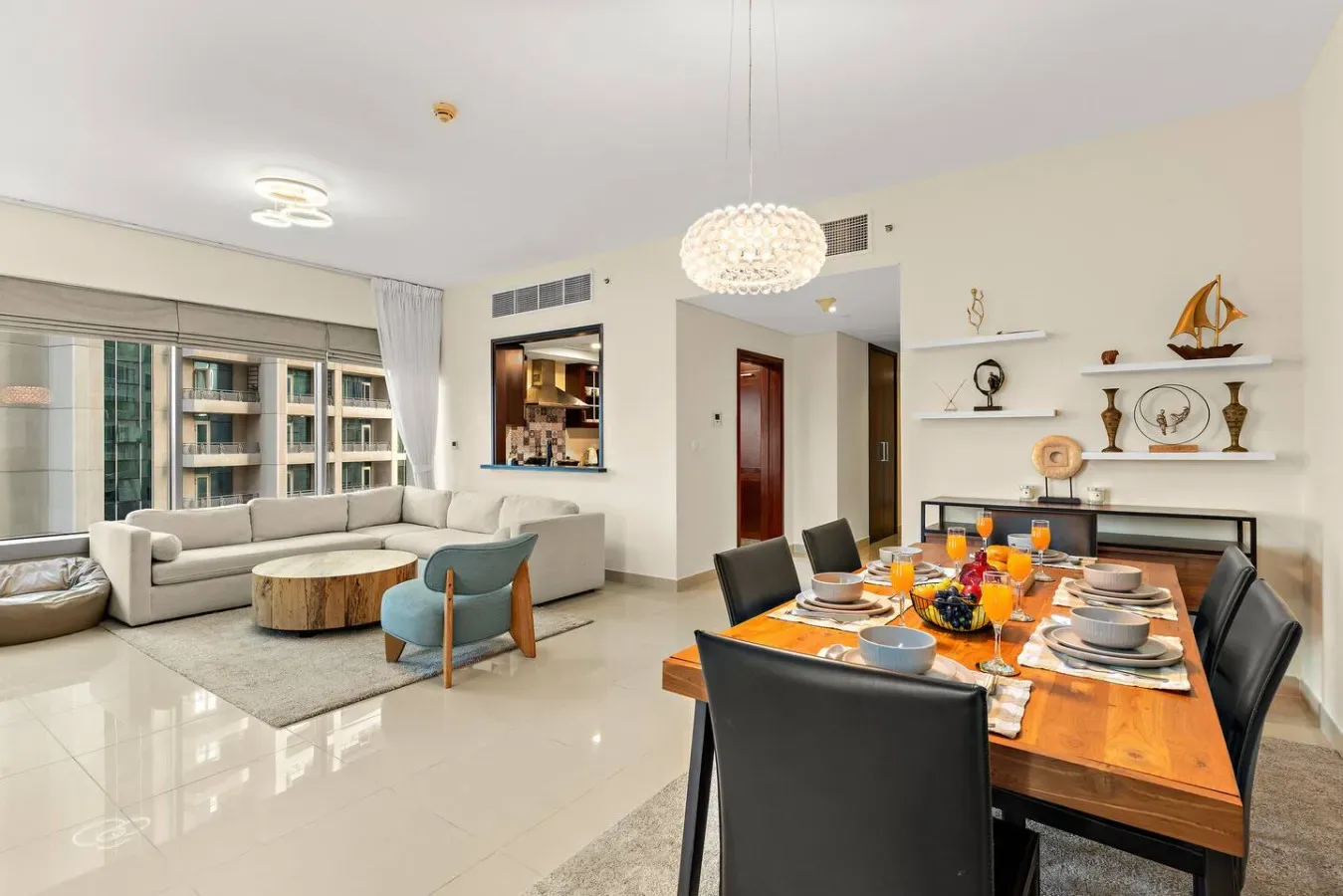A bright living and dining area with a seating area beside a set dining table.