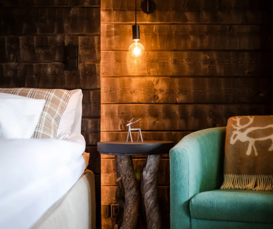 Timber bedroom with warm lighting and wooden furnishings.
