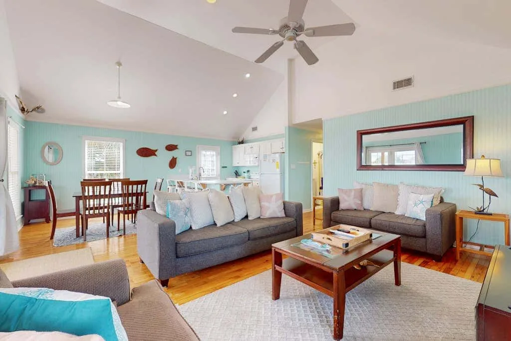 A living and dining room with seating, a coffee table, and a dining table.