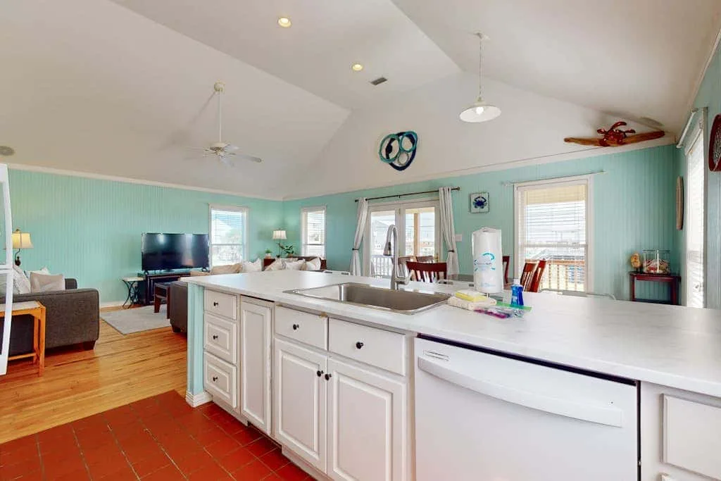 An open kitchen and living area with a large island and seating.