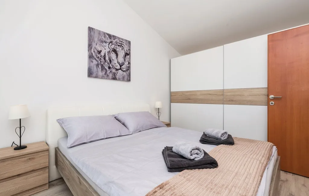 Bedroom with a bed, bedside tables, and a large wardrobe.