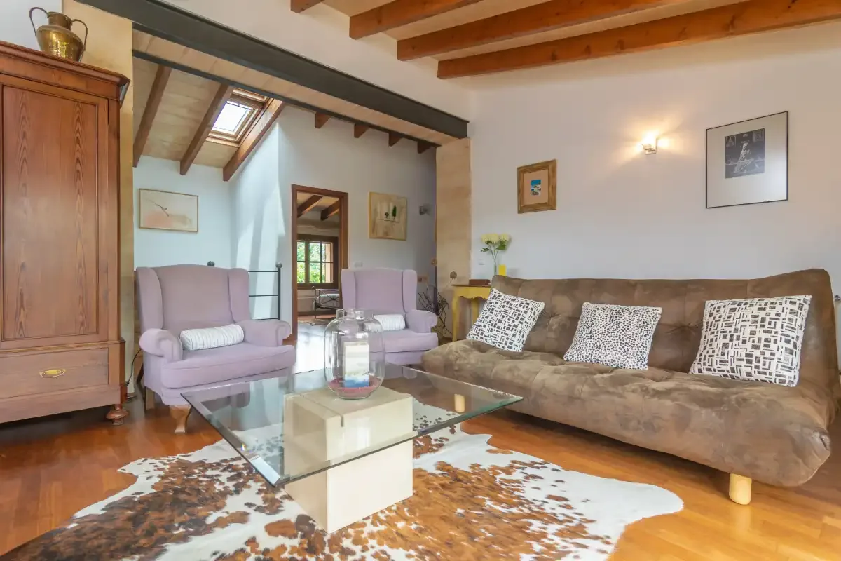 A living room with seating around a glass coffee table.