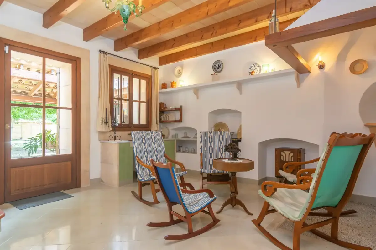A bright living room with wooden seating and a small round table.
