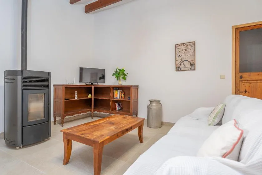 A bright living room with a wooden coffee table and a white sofa.