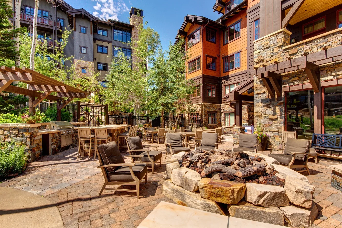 An outdoor courtyard with seating around a stone fire pit.