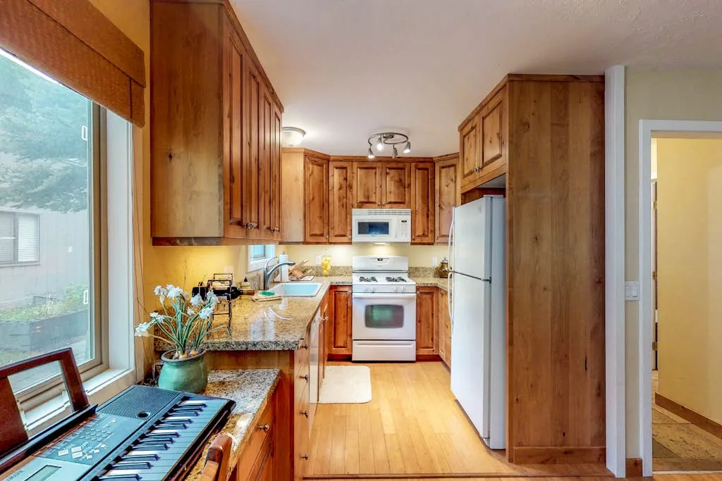 A kitchen with wooden cabinets, countertops, and appliances.