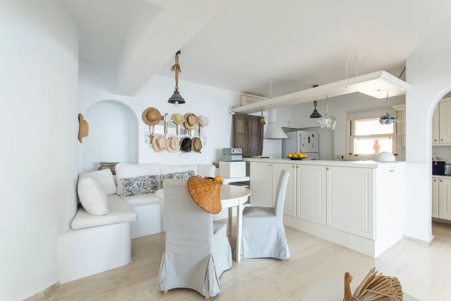 Bright dining area with covered seating beside an open kitchen.