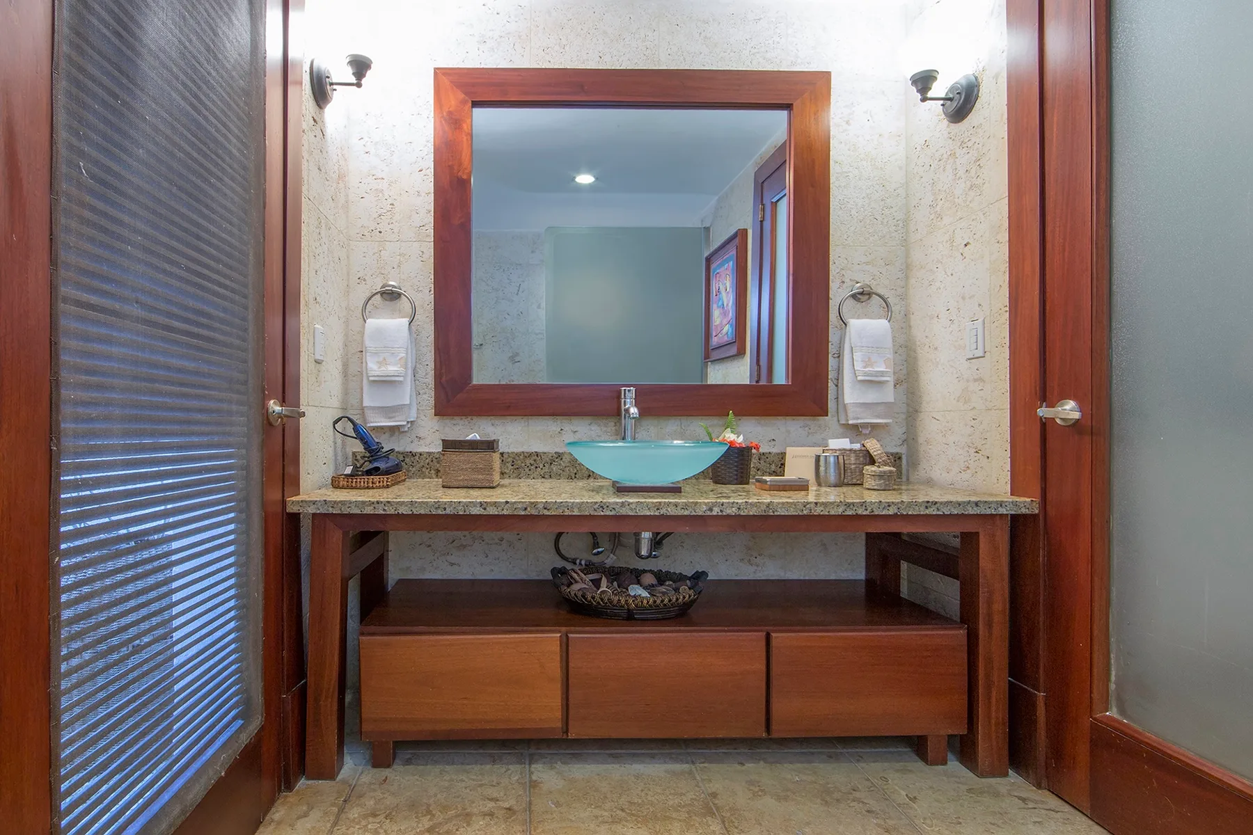 Un mueble de baño con un espejo amplio y un lavabo turquesa.