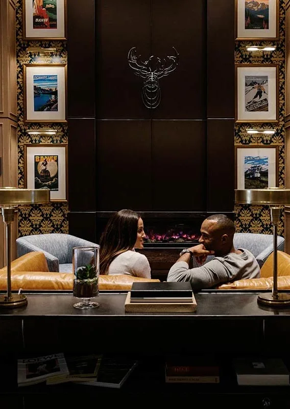 Guests seated by the fireplace in the hotel lobby.